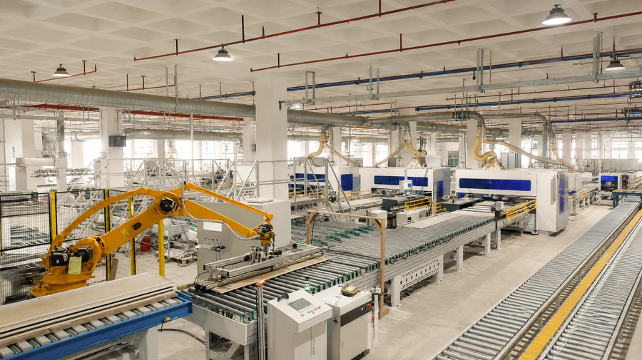 Factory floor with team operating industrial equipment